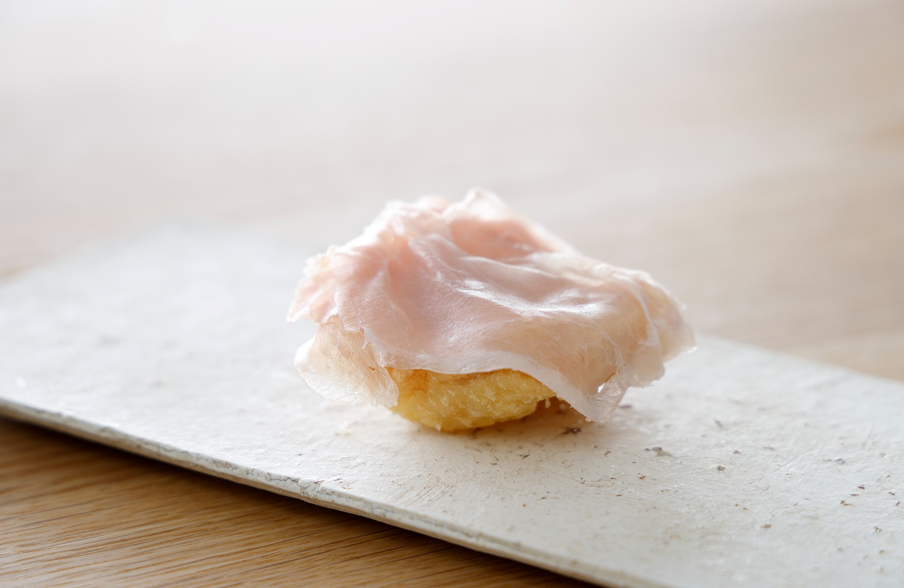 Gnocco fritto, as reimagined at shiro, where crisp fried bread meets seared conger eel and melting prosciutto in a quiet collision of Italian technique and Japanese coastal depth. © shiro