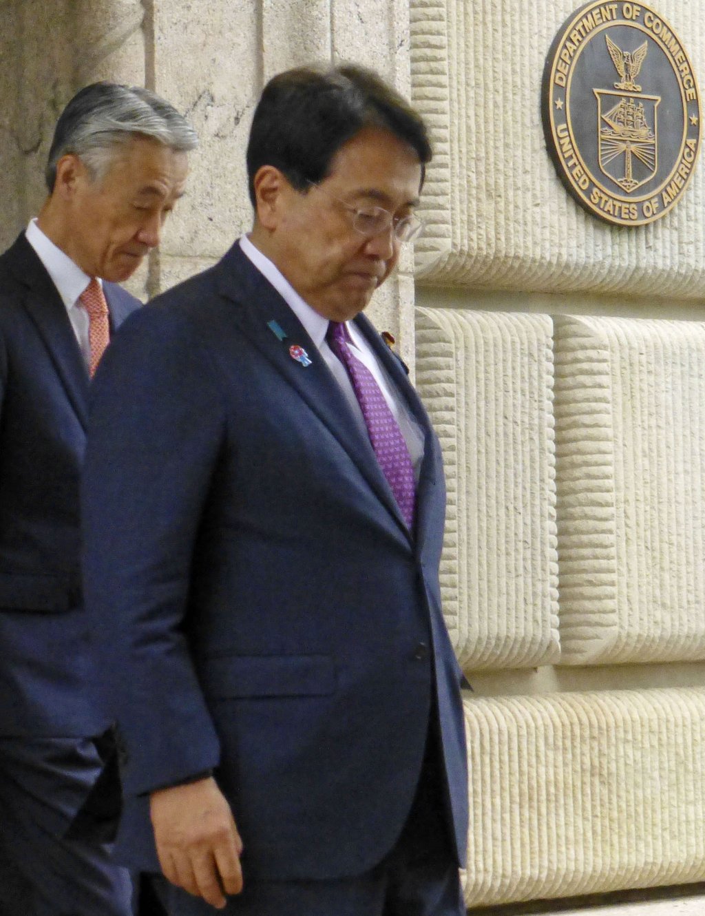 Japan’s chief tariff negotiator Ryosei Akazawa (right) leaves the US Department of Commerce in Washington after holding talks with US Commerce Secretary Howard Lutnick on June 27. Photo: Kyodo
