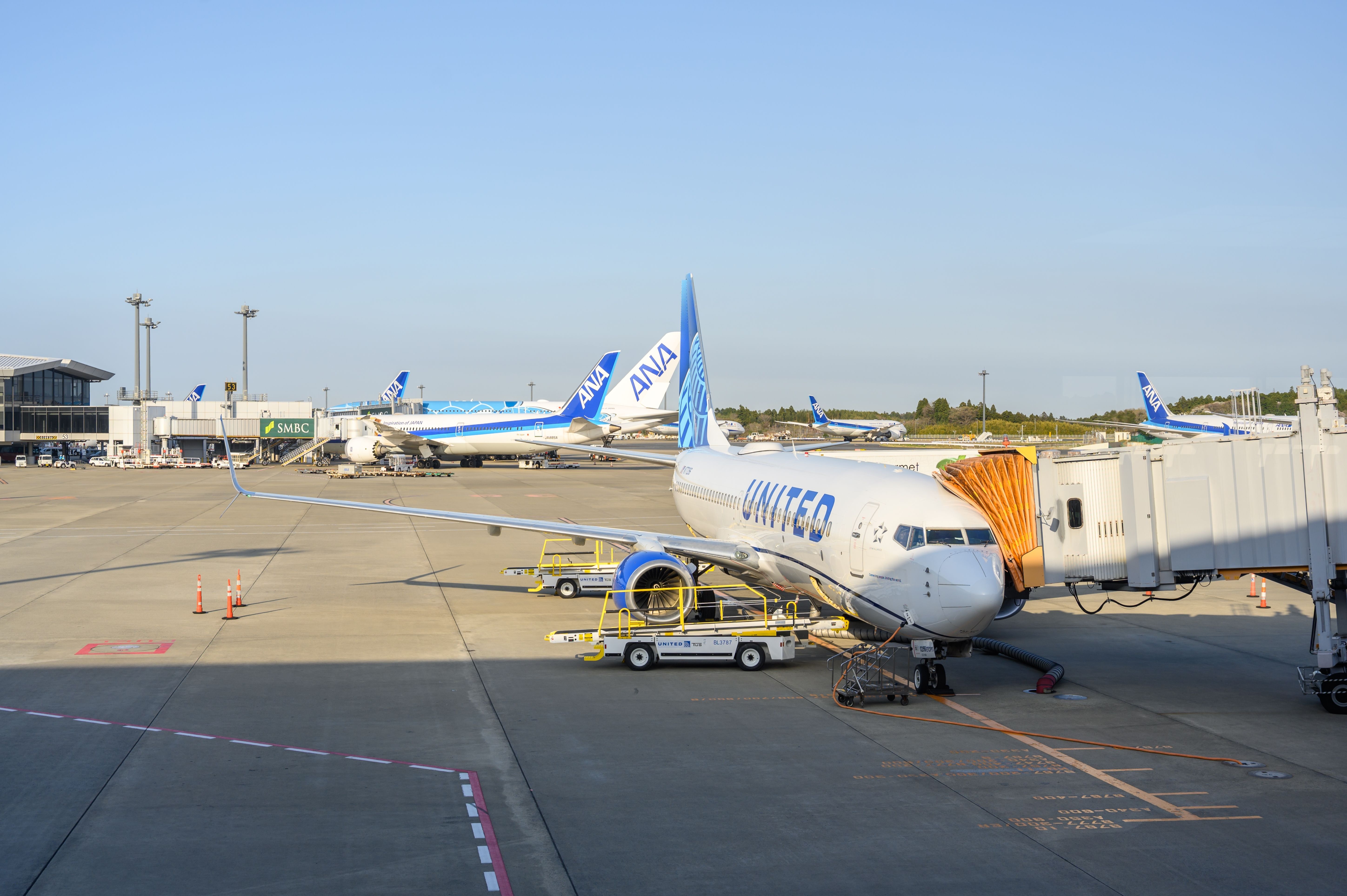 April 9, 2025 - United Airlines aircraft being serviced, parked at passenger gate at Narita International Airport (NRT), Tokyo