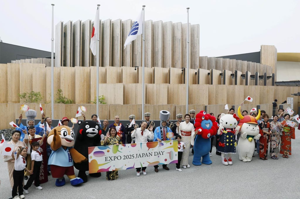 Mascots and expo staff pose for a photo in front of the Japan Pavilion at the World Expo in Osaka on July 3. Photo: Kyodo