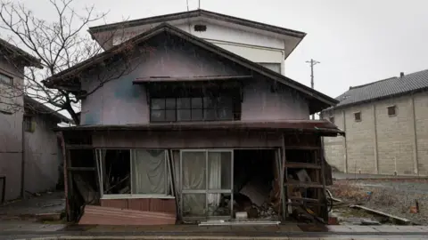 Getty Images An abandoned house sits along the main street in Fukushima prefecture
