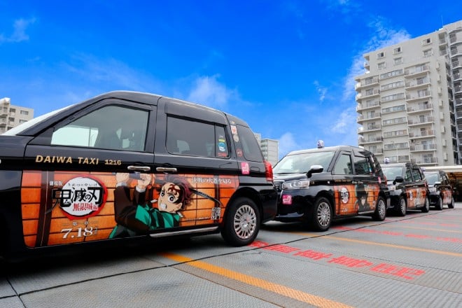 Demon Slayer wrapped taxi driving in Tokyo featuring main characters