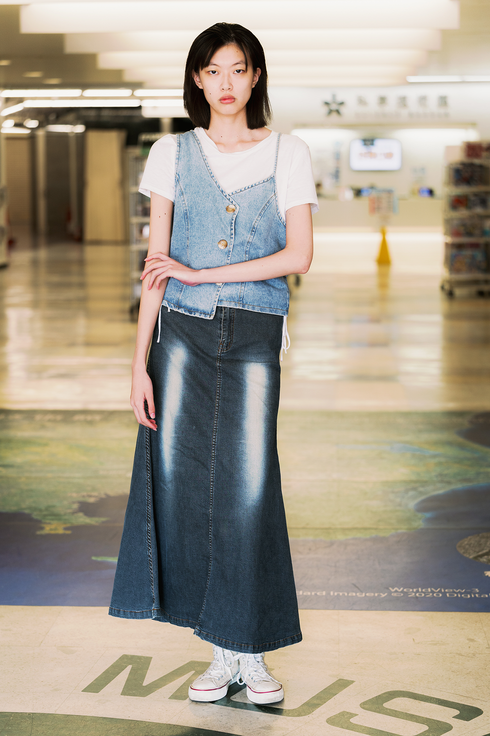 tokyo, japan september 05: a guest is seen wearing white t shirt, jeans vest, jeans maxi skirt and white sneakers during rakuten tokyo fashion week s/s 2025 on september 05, 2024 in tokyo, japan. (photo by mila gruber/getty images)
