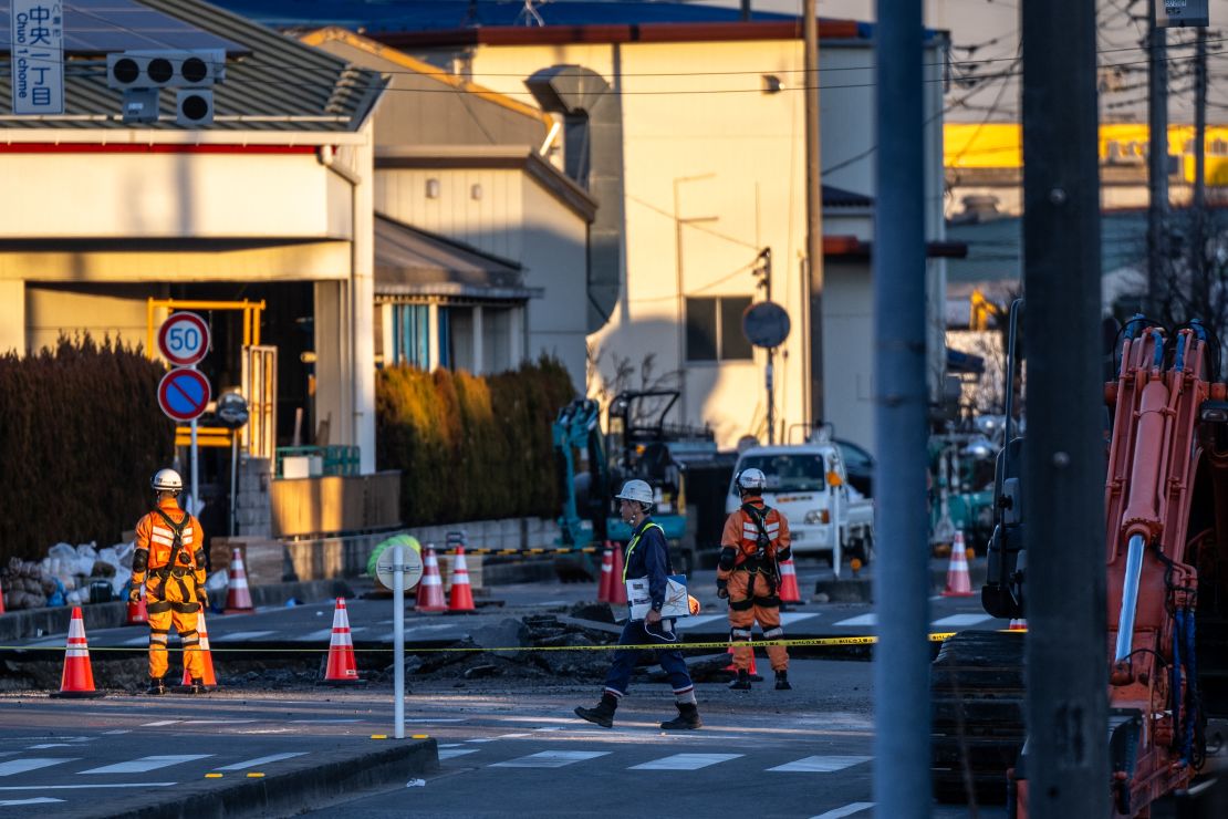 Rescue operations continue for a truck driver after his vehicle plunged into a sinkhole in Yashio, Saitama Prefecture.