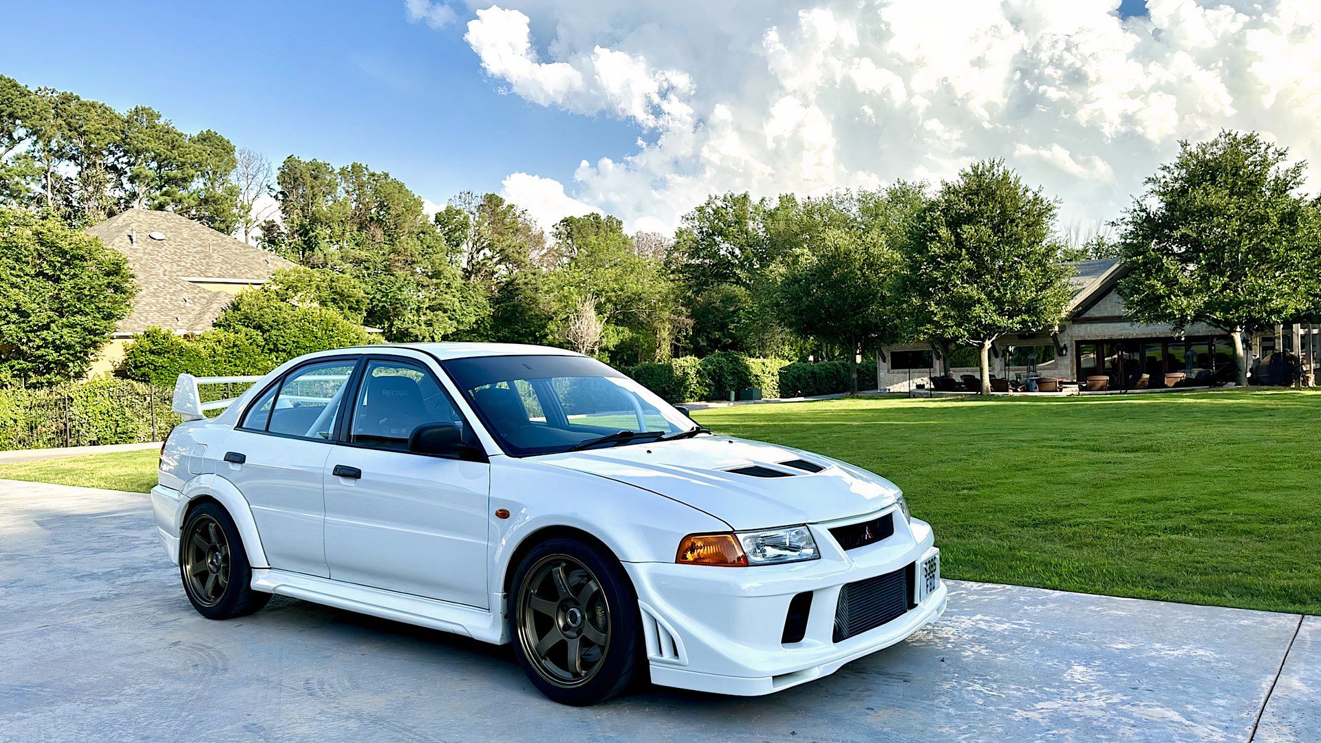 1999 Mitsubishi Lancer Evolution VI GSR in white parked on driveway