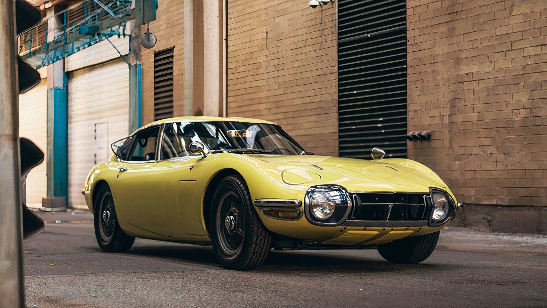 1967 Toyota 2000GT in yellow parked in alley