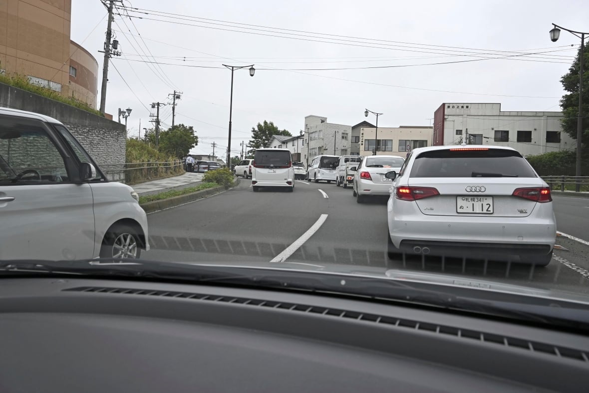 Motorists drive to higher ground in Kushiro, Hokkaido, Japan, following a tsunami warning.