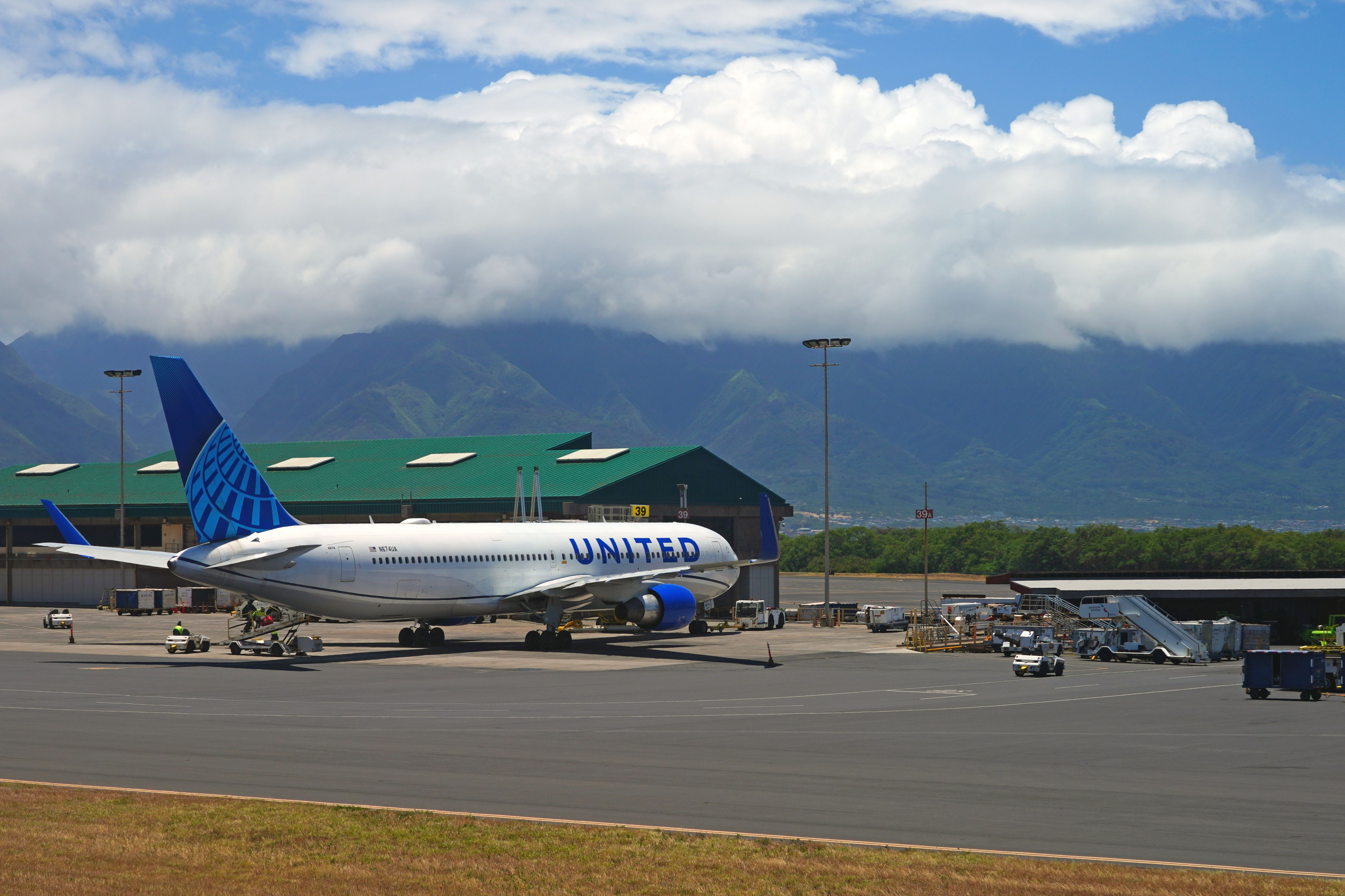 View of a United Airlines (UA) airplane at the Kahului Airport (OGG) on the island of Maui in Hawaii near the Haleakala volcano.