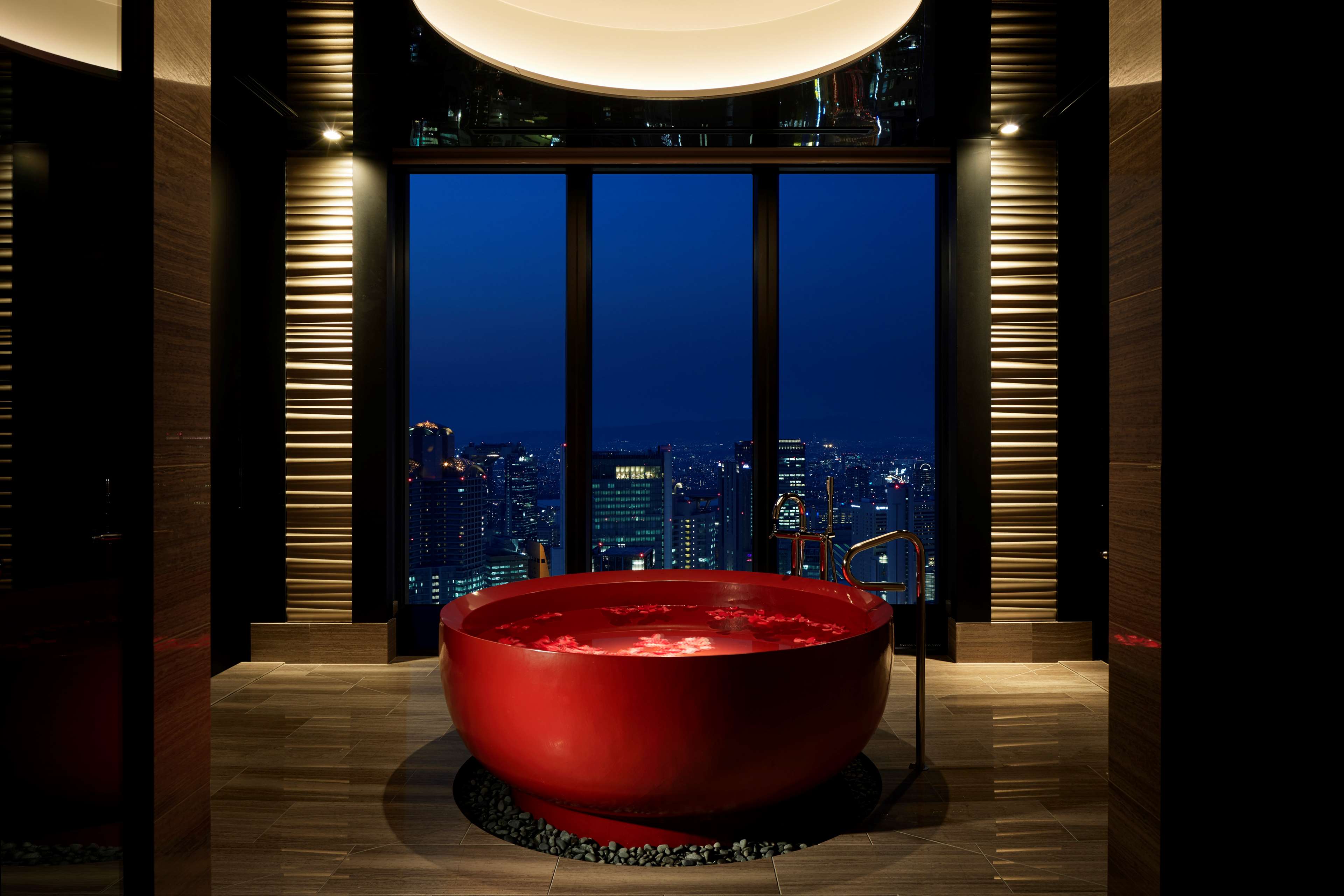 A circular bathtub overlooking the city at the Conrad Osaka hotel