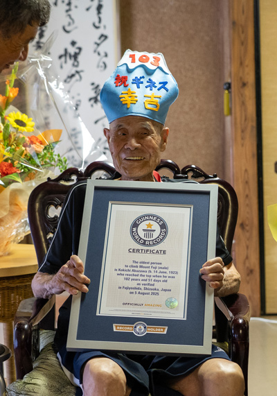 Kokichi holding his official certificate