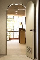 A rounded, arch-shaped door adds a sense of warmth to the simple wall surface, as seen at the Matsumoto Memorial Music Guest House in Tokyo's Setagaya Ward, April 17, 2023. (Mainichi/Akihiro Ogomori)