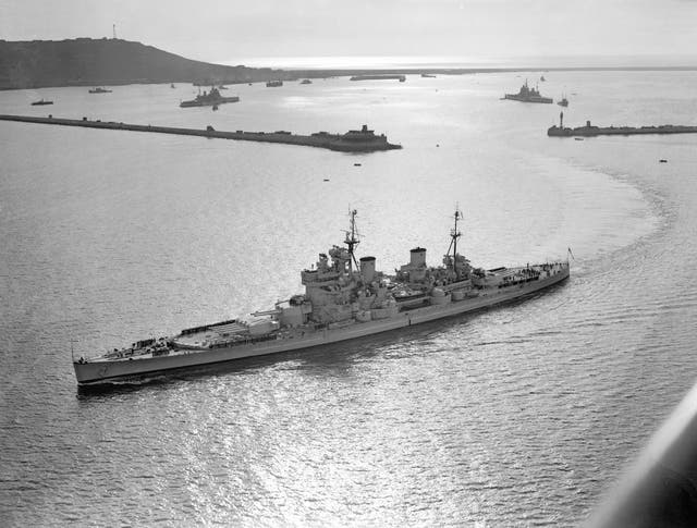 HMS Duke of York passing through the breakwater at Portland Harbour, Dorset 
