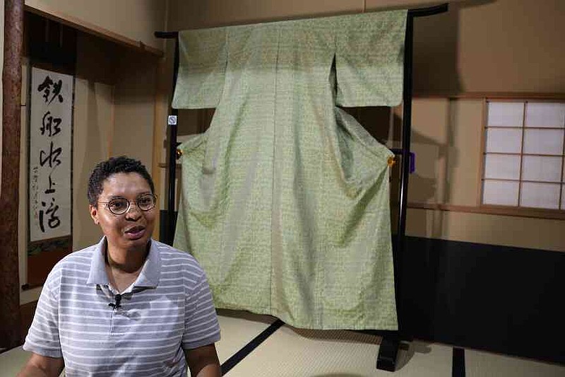 Lana Sinapayen, associated researcher at Sony Computer Science Laboratories, speaks with The Associated Press about the Nishijinori AI project with the fabric in the background in Kyoto, western Japan on July 3, 2025. (AP Photo/Yuri Kageyama)