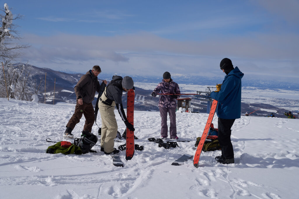Learning how to apply skins to a splitboard. Image: Aron Tarjani