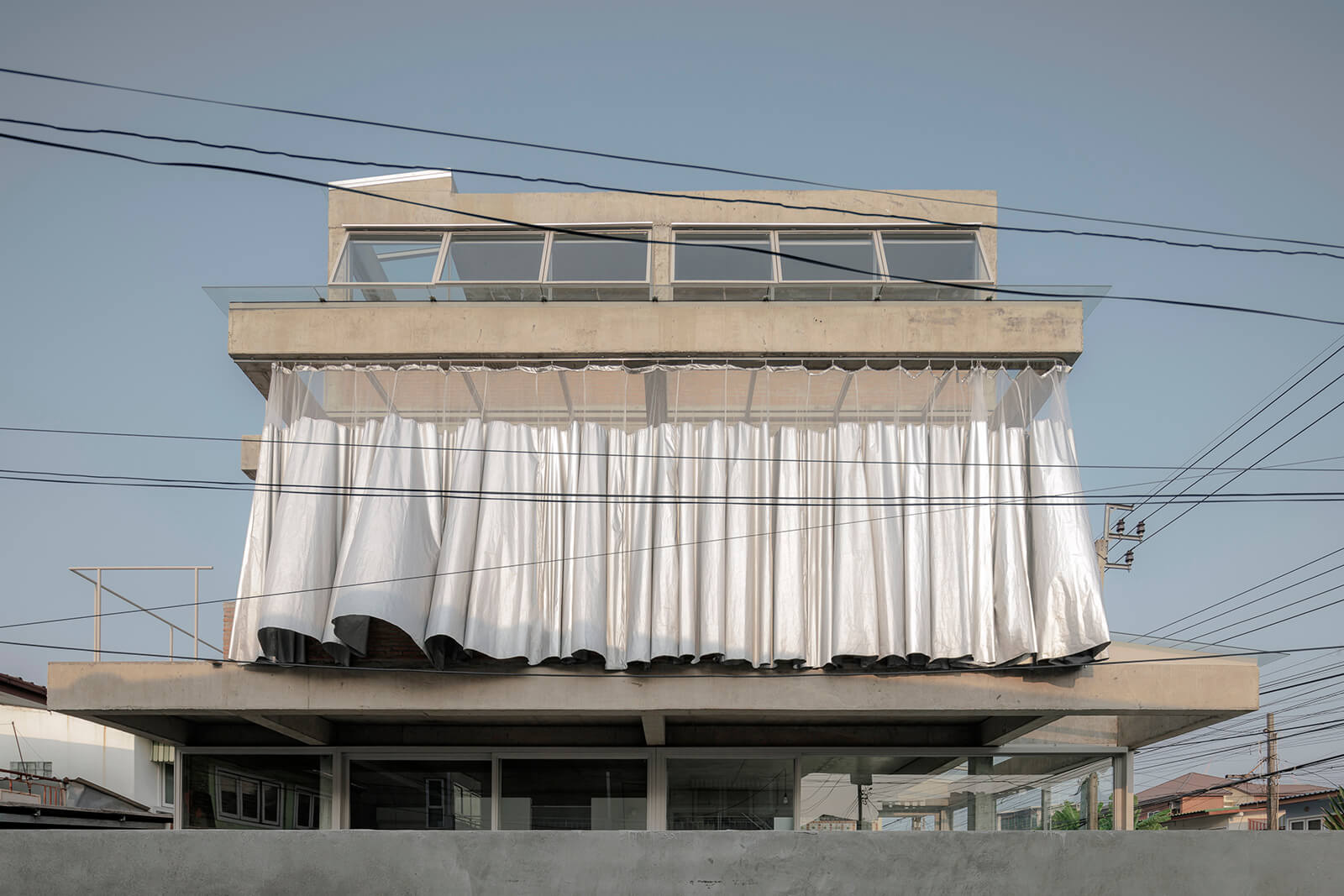 The design of House K (Bangkok, 2023) is characterised by a large curtain on its external facade | Bangkok Tokyo Architecture | Thailand | STIRworld