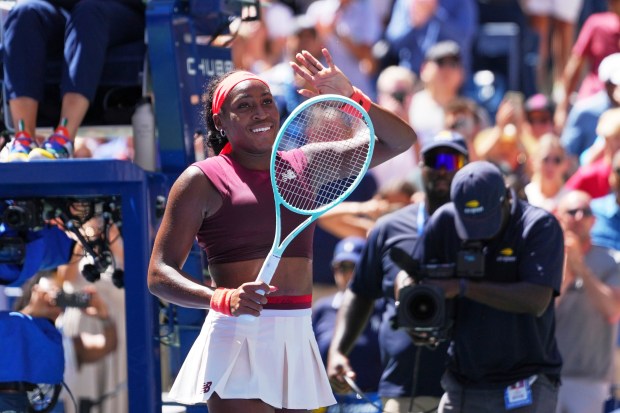 Coco Gauff, of the United States, waves after winning the...