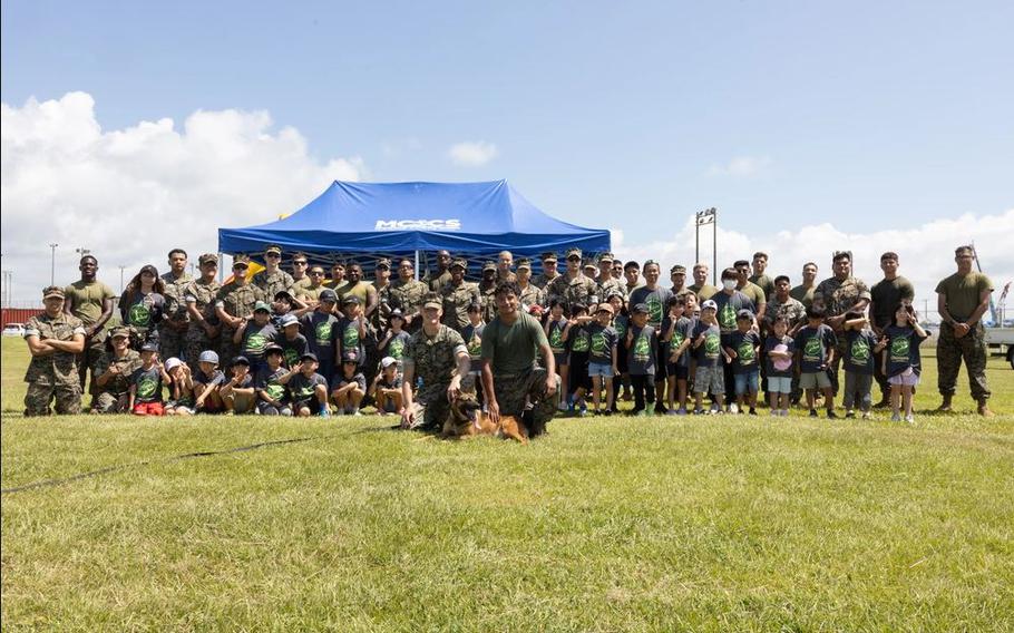 U.S. Marines with Marine Corps Installations Pacific and students from Kamimotobu After-School Children’s Club pose for a group photo.
