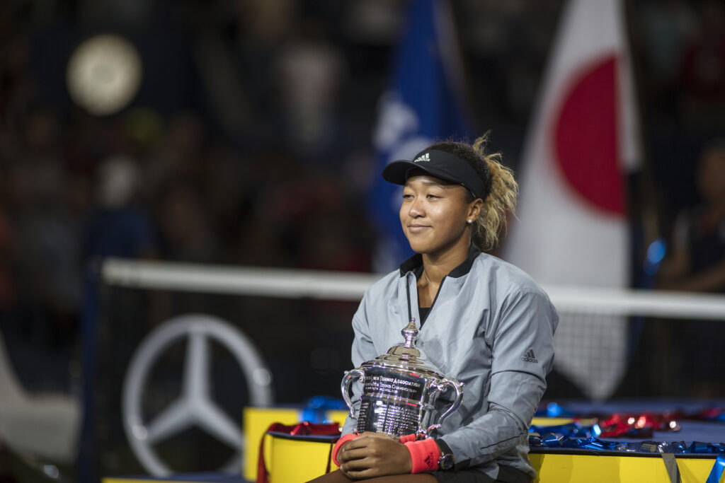 Naomi Osaka sits with the US Open trophy