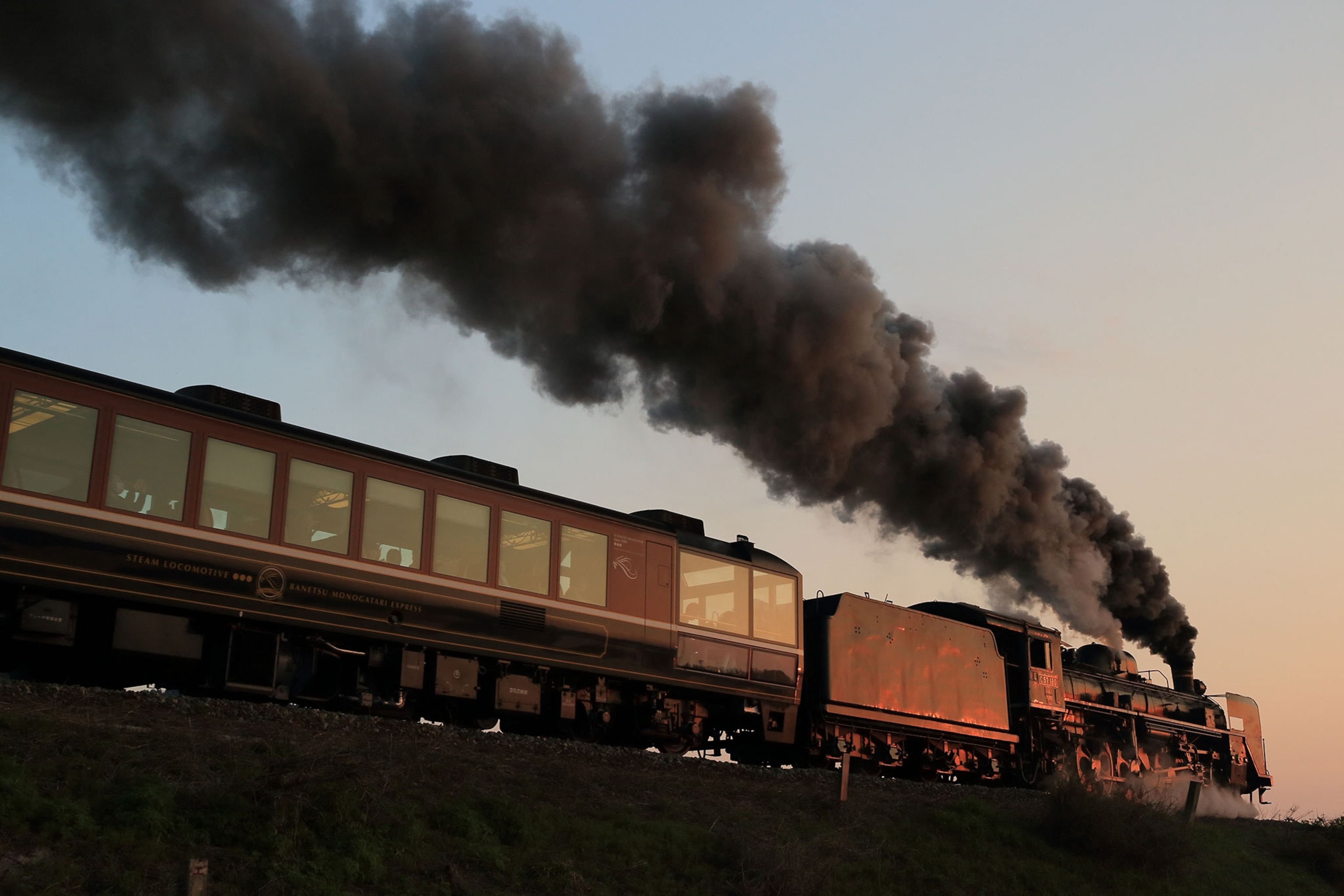 A train with smoke stack coming out of the top.
