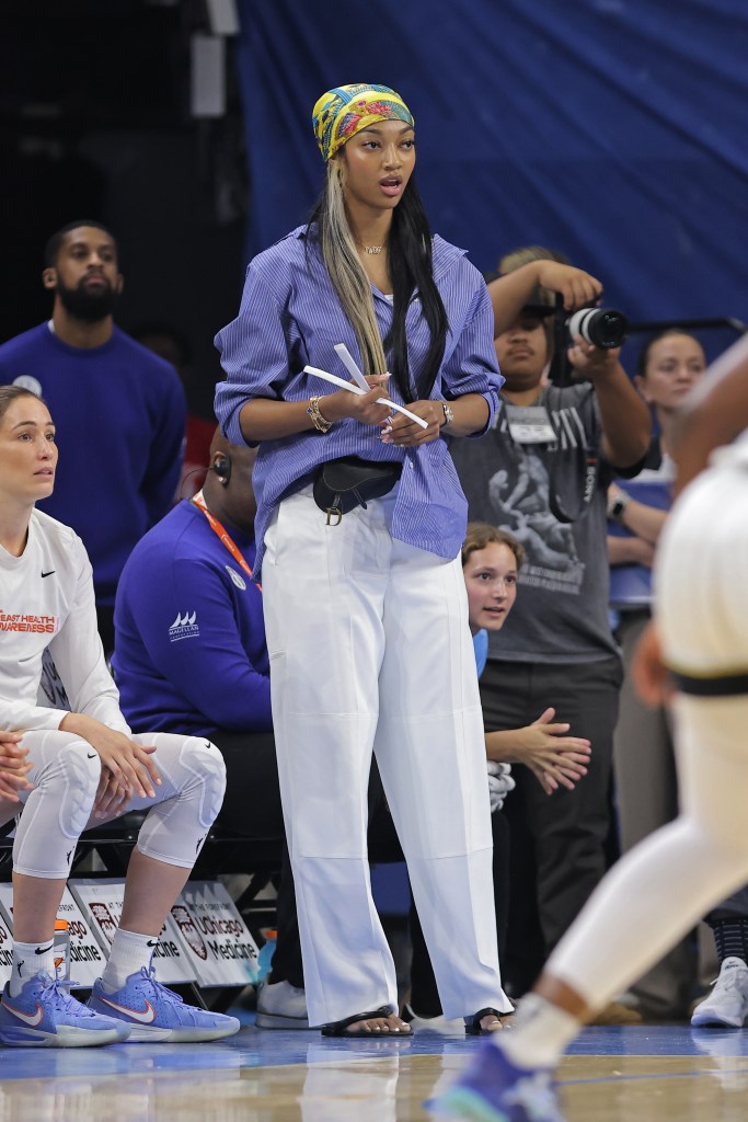 Angel Reese watches from the sidelines