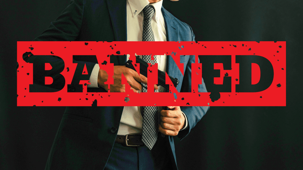 Japan’s Gun Control Laws: How The Country Stays (Almost) Gun-Free Man in suit pulling out gun from his coat with the word "BANNED" written over him