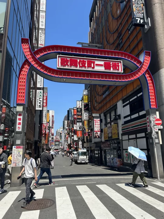 Photo of the tall, red gate into the Kabukichō district in Shinjuku, Tokyo. 