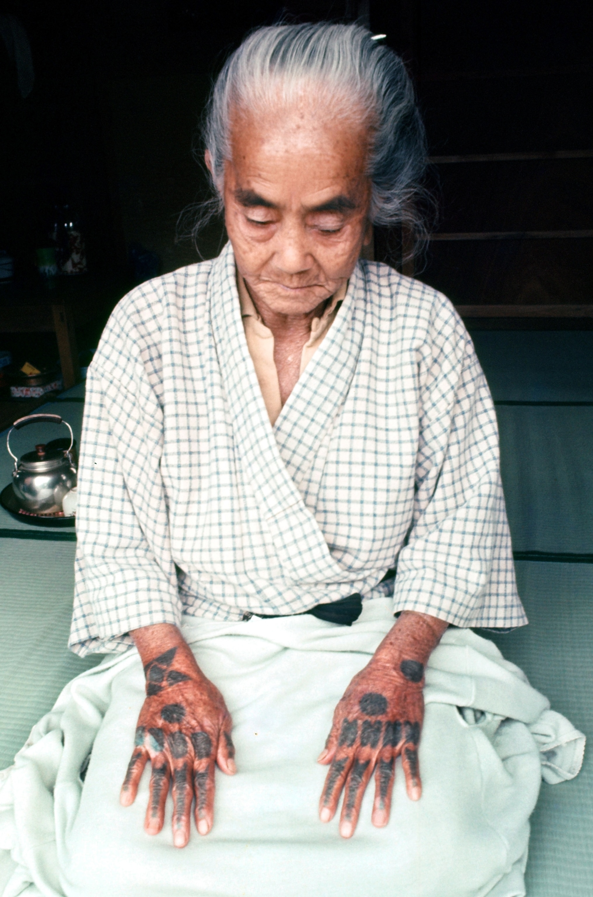 An elder Ryukuan woman with tattooed hands