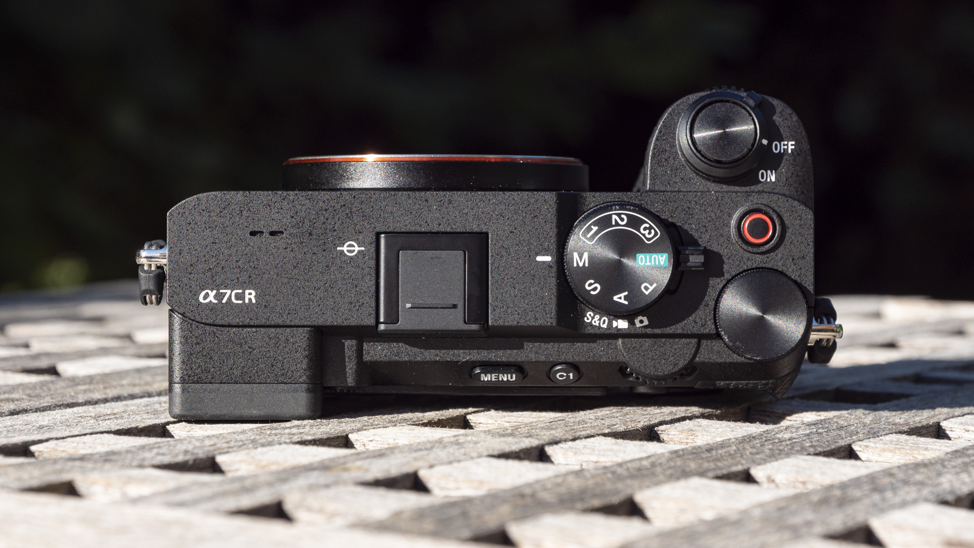 Top plate of the Sony A7C R mirrorless camera outside on a wooden table