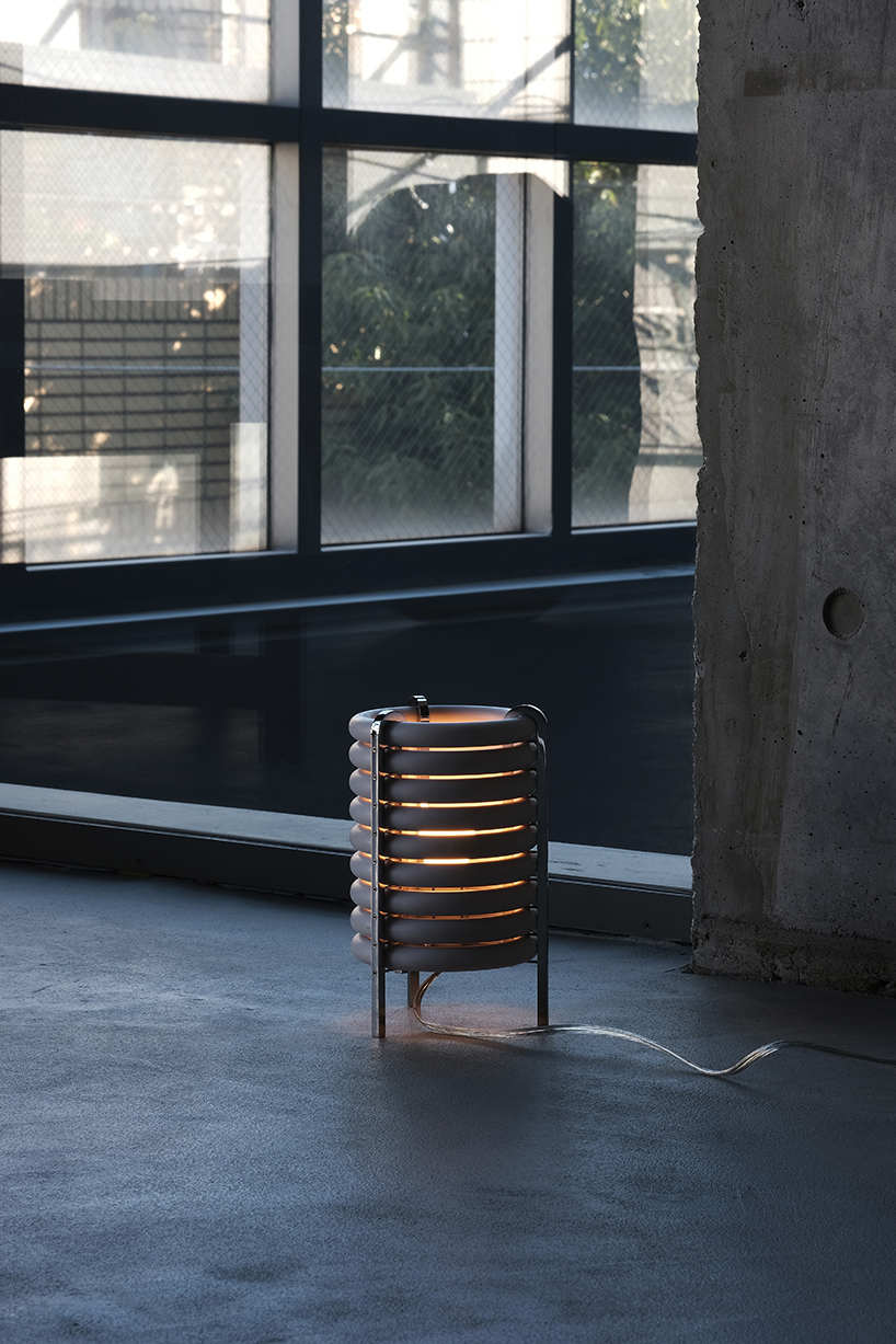 wa upcycled table lamp by akasaki & vanhuyse is crafted from retired tokyo train parts