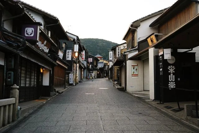 Daniel Gorostieta/Travel + Leisure A Kyoto street lined with businesses.