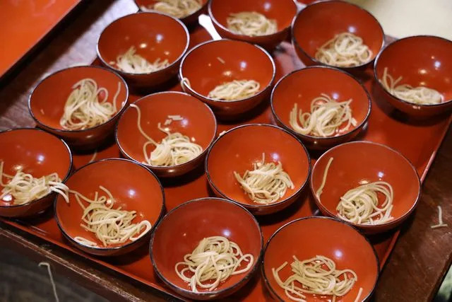 Tohoku Tourism Promotion Organization Bowls of soba being prepared at Azumaya Soba.