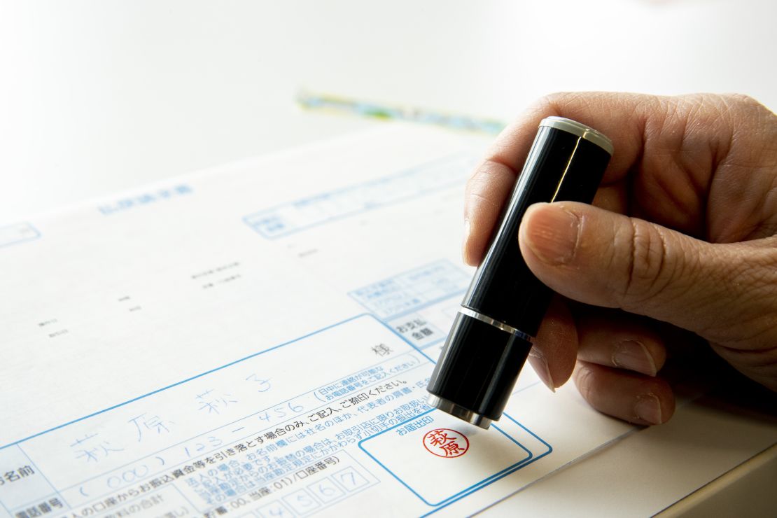 A hanko is stamped on a banking document in an arranged photograph taken in Tokyo, Japan.