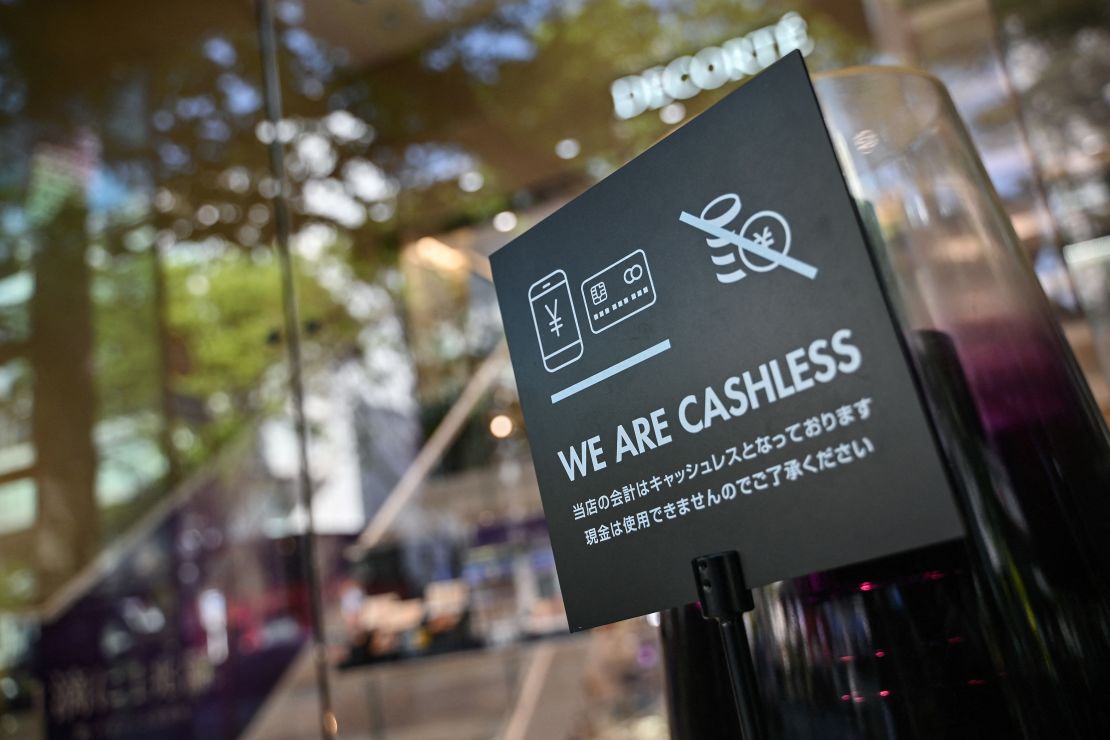 A sign for cashless payments outside a shop in the trendy Omotesando district of Tokyo.