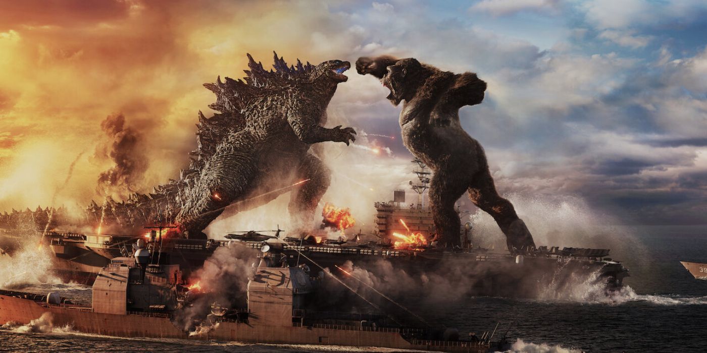 Godzilla fighting King Kong in the ocean near a warship from Godzilla vs Kong.