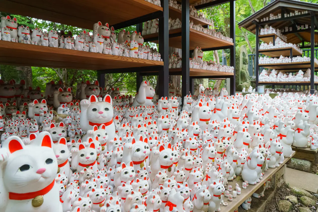 Rows of Maneki-neko “beckoning cat” statues at Gotokuji Temple in Tokyo, Japan, the site considered the birthplace of the lucky cat tradition.