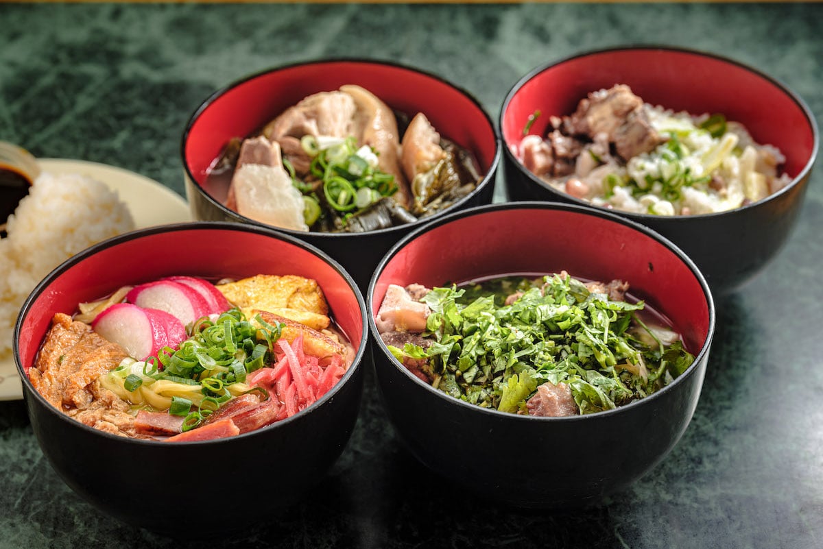 four red wooden bowls of okinawan soups