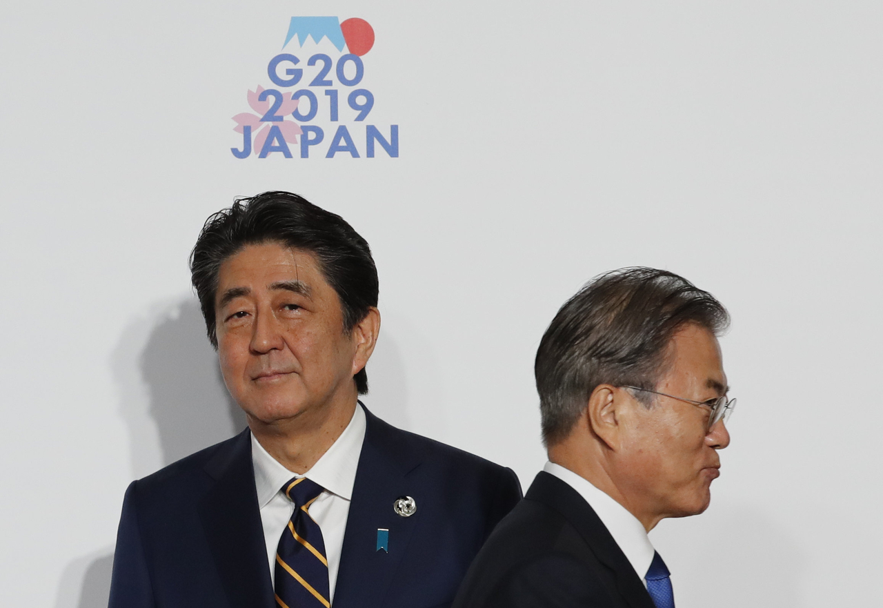 South Korean President Moon Jae-In is welcomed by Japanese Prime Minister Shinzo Abe before a group photo session at the G20 summit on June 28, 2019 in Osaka, Japan. (Getty Images)