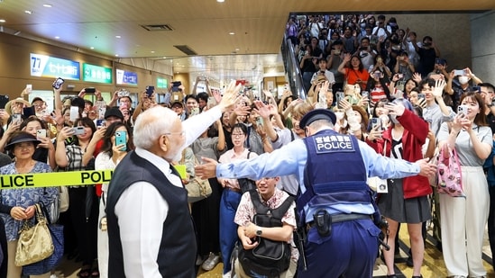 Prime Minister Narendra Modi waves as he is being greeted by the locals and Indian diaspora upon his arrival, in Sendai on Saturday.(PMO/ANI)