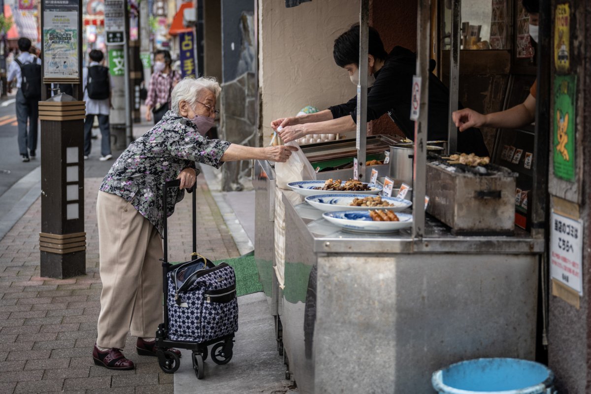 Woman Buys Chicken in Tokyo