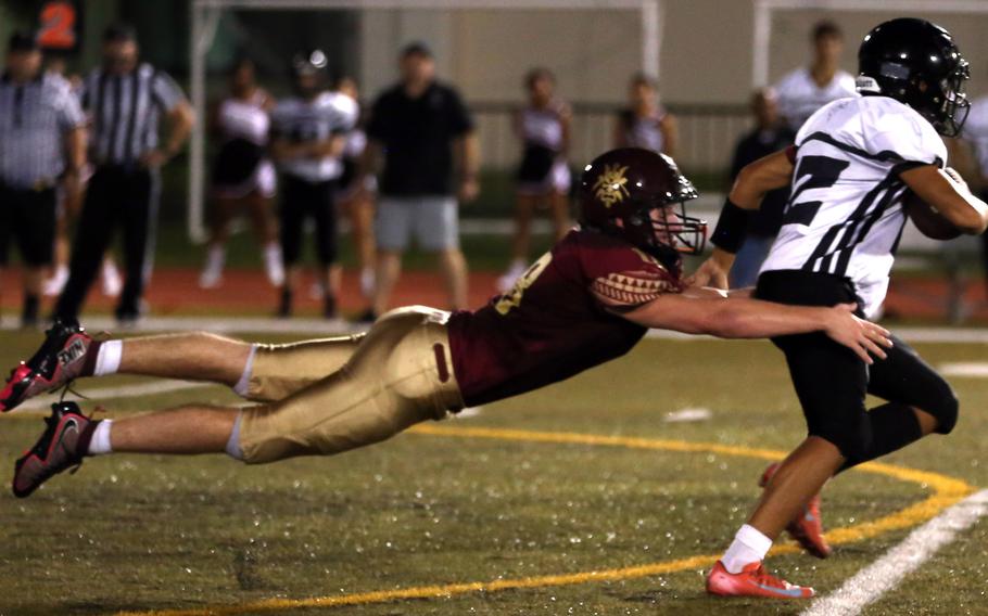 Kelton Clark dives for a tackle.