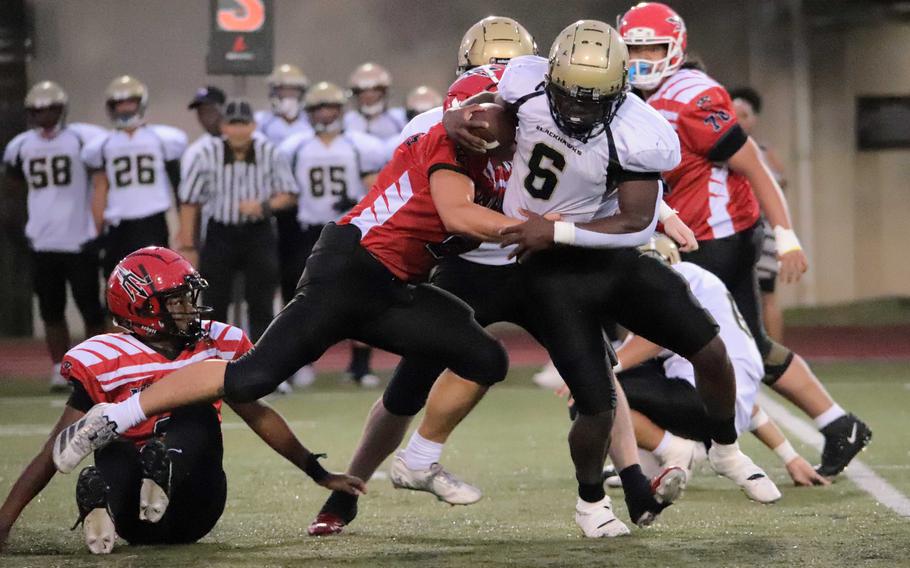 Joshua Canion is tackled by Jacob Bojorquiz.