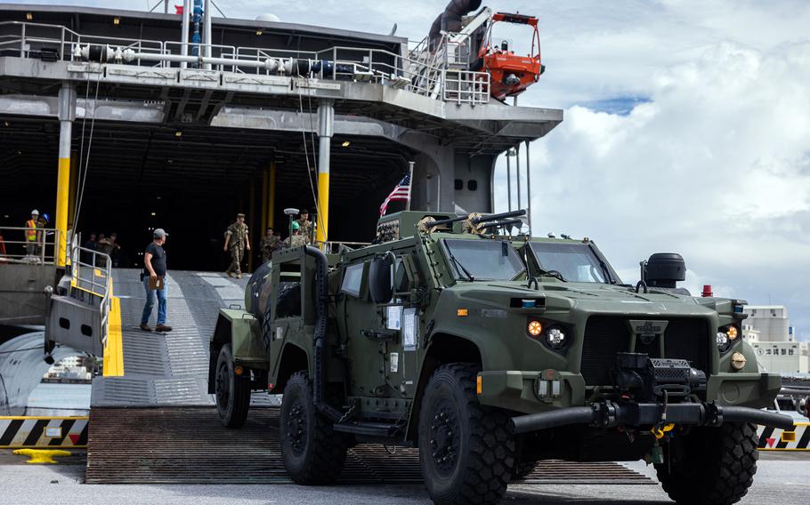 Members of the 3rd Marine Division unload a Navy-Marine Expeditionary Ship Interdiction System.