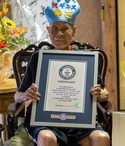 Kokichi Akuzawa displays his Guinness World Records certificate