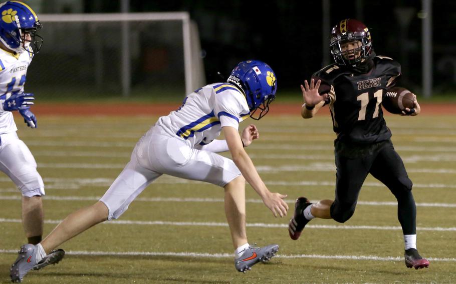 Perry's Kameron Ramos tries to outrun Yokota's Abraham Ponce.