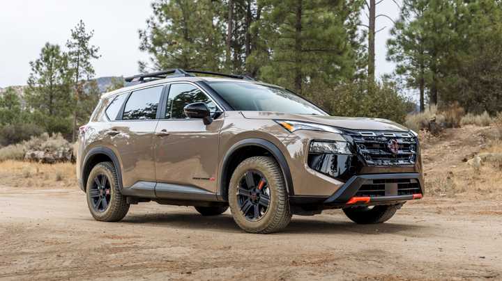 2025 Nissan Rogue Rock Creek Bronze Front Angle on Dirt