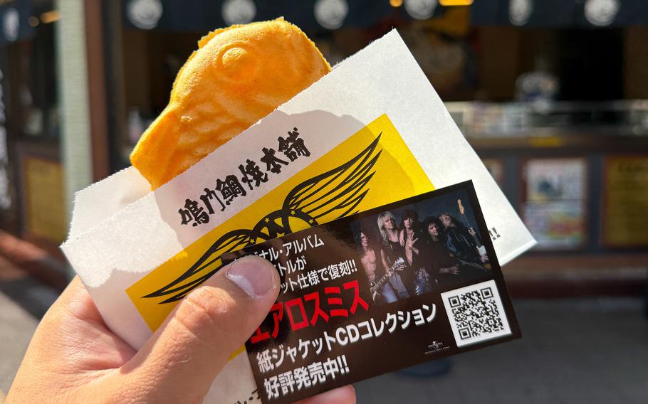 A cardboard snack holder is decorated in an Aerosmith theme.