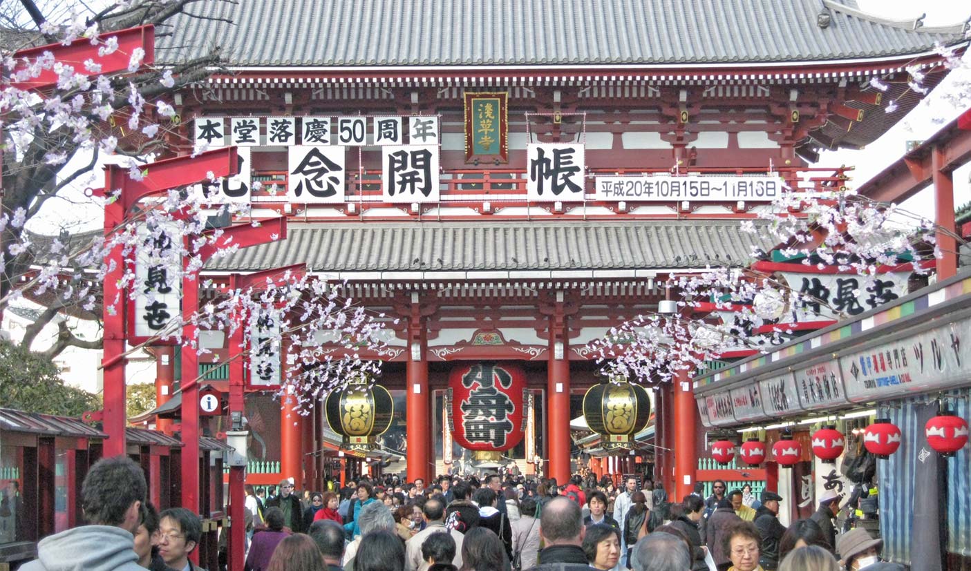 Crowds walk toward the big red gate of Senso-ji, Tokyo's oldest temple