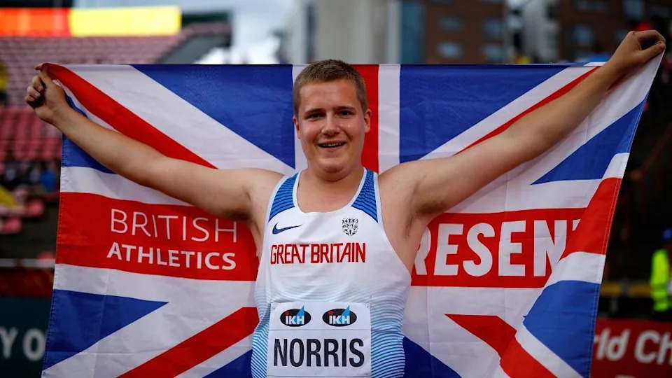Jake Norris holds up a Great Britain flag after winning World Under-20 gold in 2018