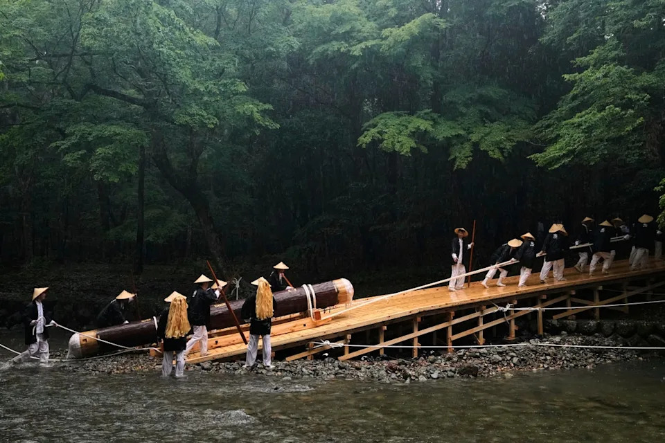 People pull a sacred timber up from a creek, carrying into the Kotaijingu, also known as Naiku, or the inner sanctuary, of the Ise Jingu shrine complex (Copyright 2025 The Associated Press. All rights reserved)