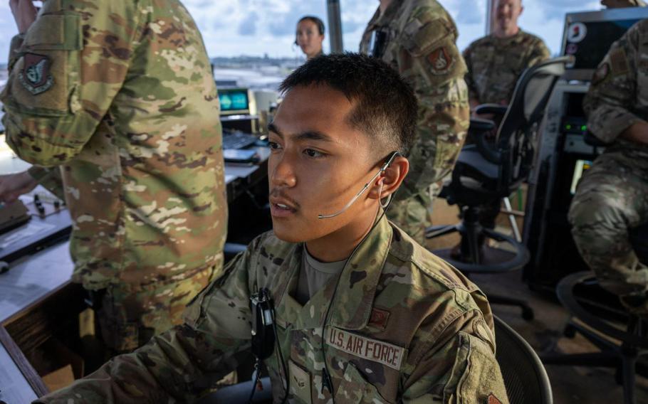 U.S. Air Force Airman 1st Class Leo Gerard Lampa, 18th Operations Support Squadron air traffic control tower specialist, reviews monitors at Kadena Air Base.